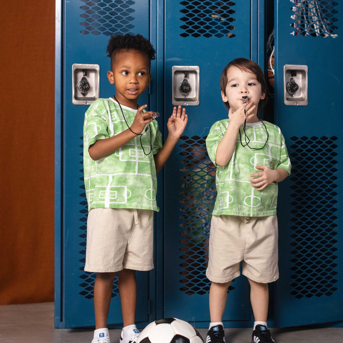 Light beige basic shorts, elastic waistband and knee-length pull-on fit on kids