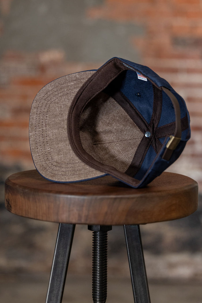 Ampal Creative The Skull - Navy Snapback. on stool standing on its side