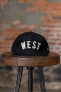 Ampal Creative West - Snapback. on stool front profile