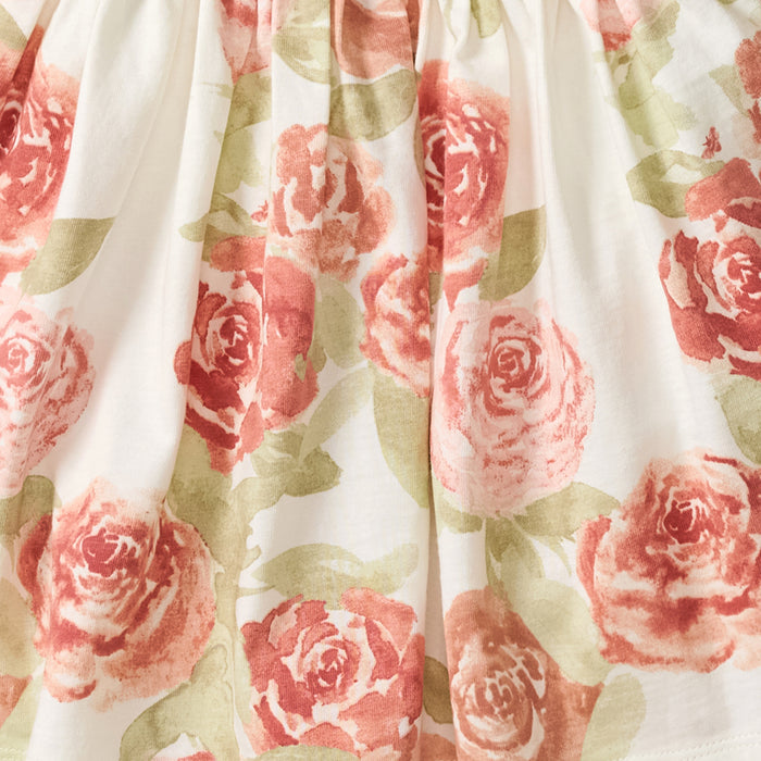 Floral tunic top with long sleeves, cream base and pink rose print; elastic waist
