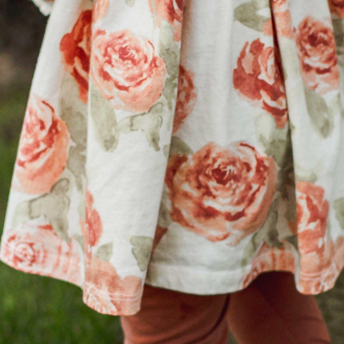 Cream tunic fabric with red-pink rose and green leaf pattern, gathered elastic yoke