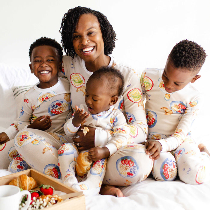 Cream matching footed pajamas on family, long sleeves with colorful food print