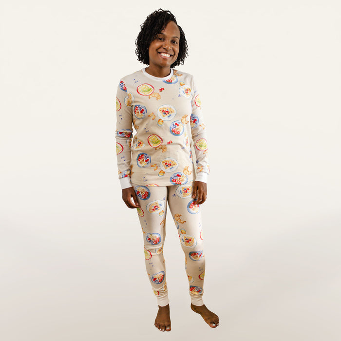 Cream pajama set on model: long-sleeve top and matching tapered pants with colorful breakfast print
