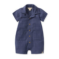 Navy checked gauze baby boy romper with button front and two chest pockets