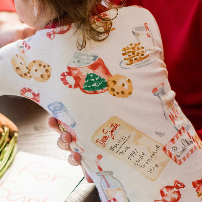 Kids footed cotton sleeper with Santa cookie-themed print, long sleeves, mitten cuffs.