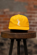 Franklin & Poe Surf Cap - Nylon Gold on stool, facing the front
