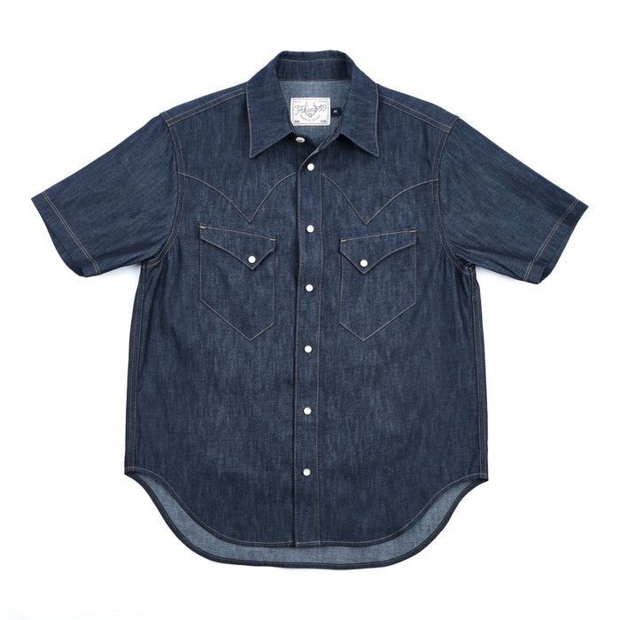 Dark indigo denim western-style short sleeve shirt with white snaps, front view laying flat