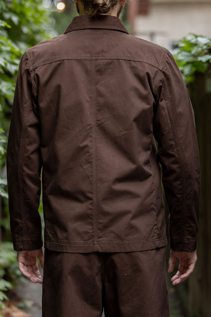 Hansen Garments Bendik Workwear Jacket - Chestnut - model shot - back facing - outside foliage background