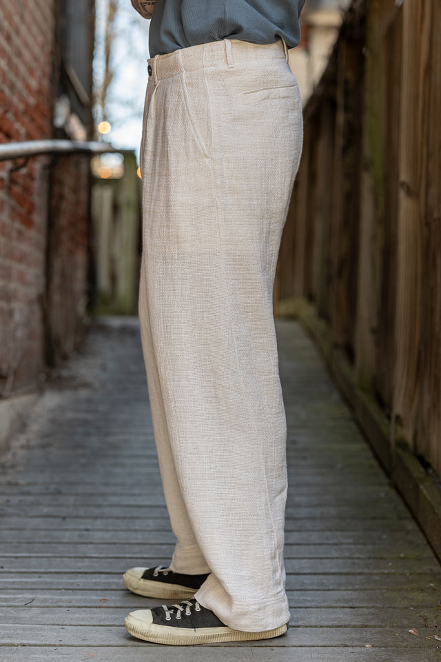 Hansen Garments Bobby Wide Pleated Trousers - Off White Gauze - model shot - waist down - side facing