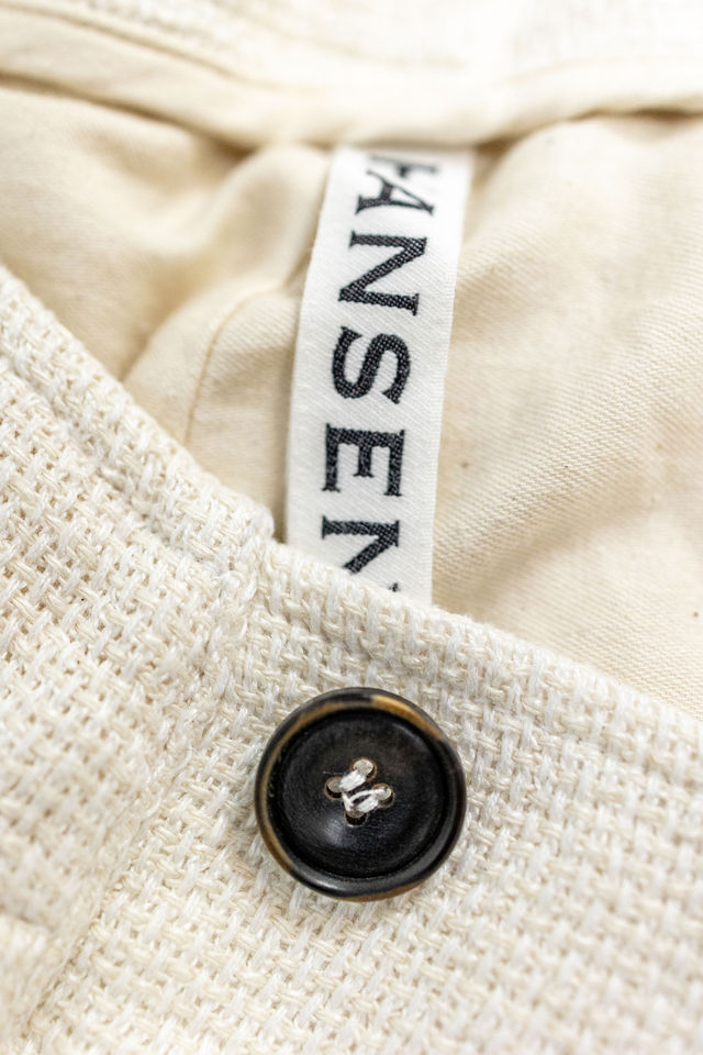 Hansen Garments Bobby Wide Pleated Trousers - Off White Gauze - product shot - close up - detail of brand tag, fabric, and button