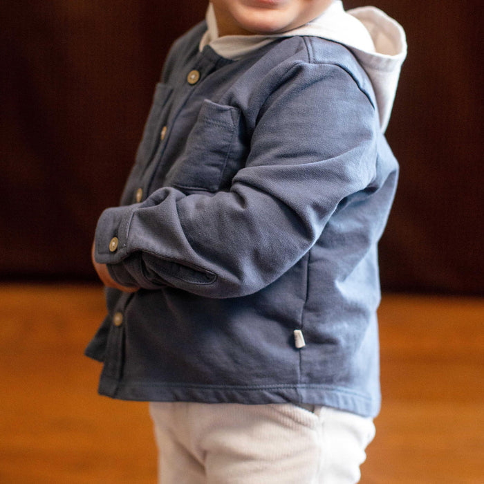 Hooded button-down shirt on child in dark blue with beige hood lining and gold buttons