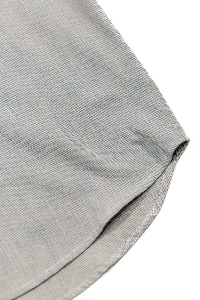 Indi + Ash LS Smith Workshirt - Handwoven Kala Cotton light blue, laying flat closeup on hem