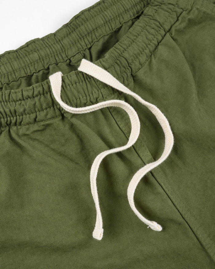 Olive mid length shorts laying flat closeup on white drawstring