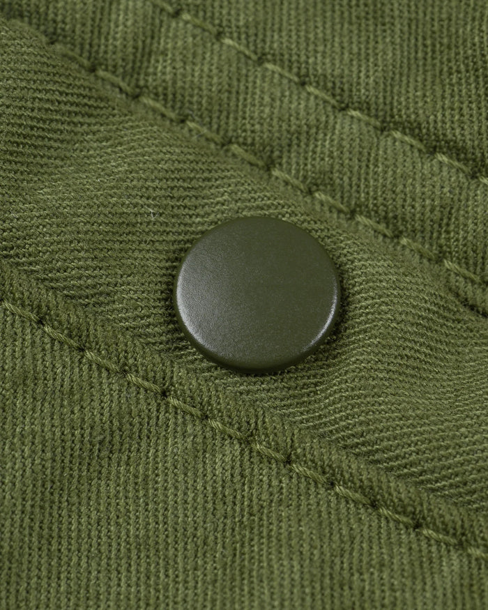 Olive mid length shorts back view laying flat closeup on snap pocket