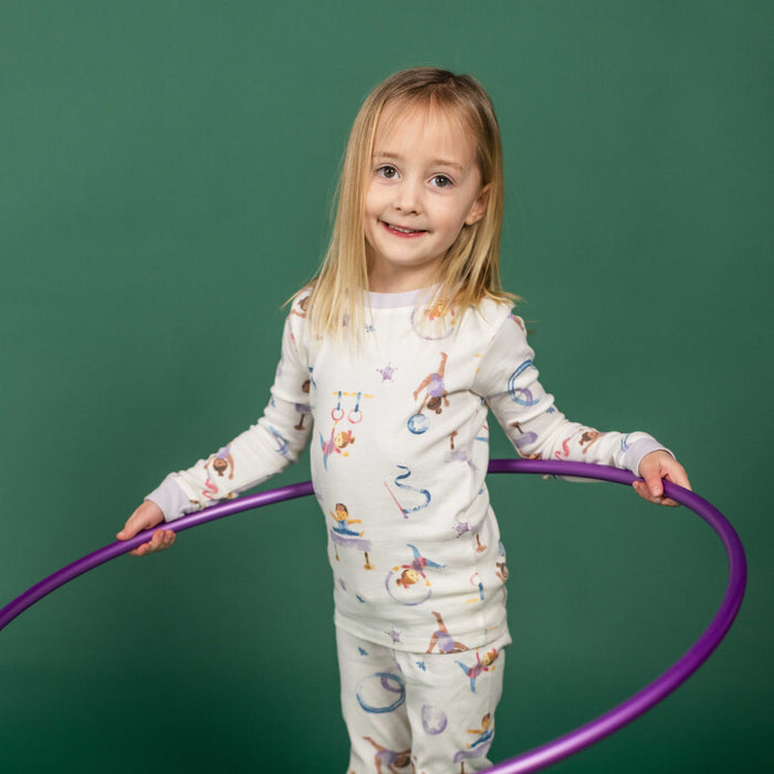 Kids' pajama set: cream long-sleeve top and pants with colorful gymnastics print