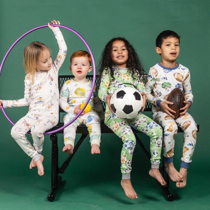 Kids' pajama set, cream long-sleeve top and pants with colorful gymnastics print