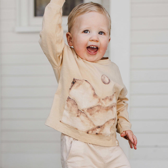 Kids long-sleeve tee in cream with watercolor mountains and moon print