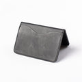 Obbi Good Label Kingsman Metro Flap Style Cardholder - Black - A black leather cardholder, displayed open, inside facing down, showcasing single external card slot against a white background