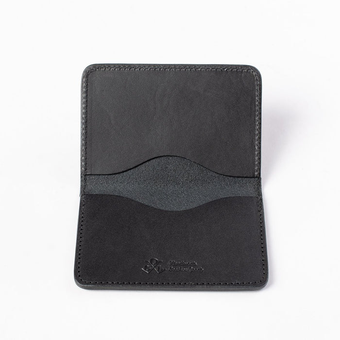 Obbi Good Label Kingsman Metro Flap Style Cardholder - Black - A black leather cardholder, displayed fully open, showcasing two internal card slots and embossed logo against a white background