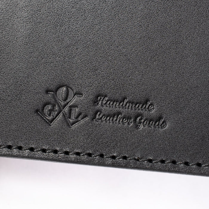 Obbi Good Label Kingsman Metro Flap Style Cardholder - Black - Close up of logo inside of wallet against a white background