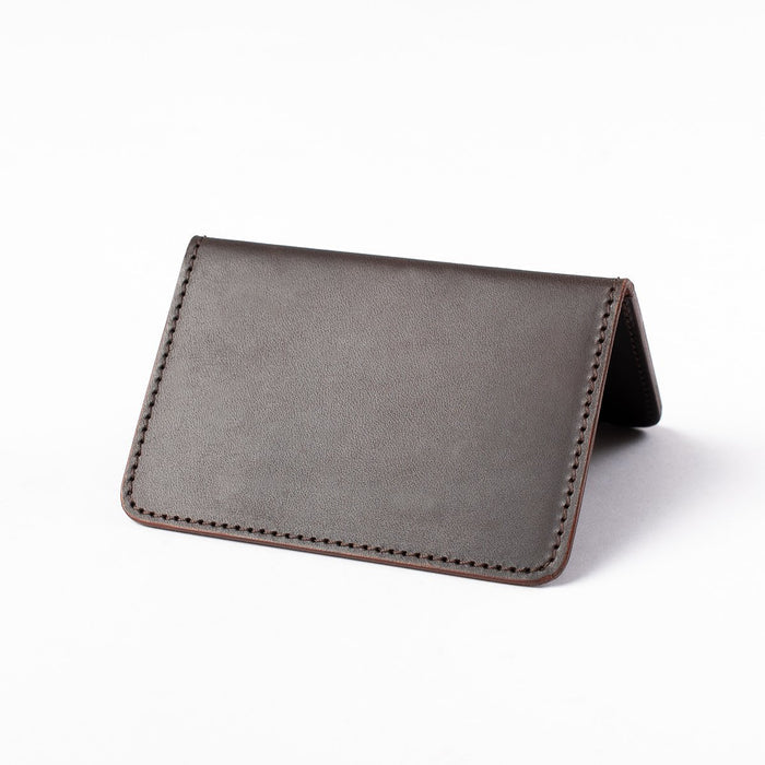 Obbi Good Label Kingsman Metro Flap Style Cardholder - Brown - A brown leather cardholder, displayed open, inside facing down, showcasing smooth external side against a white background