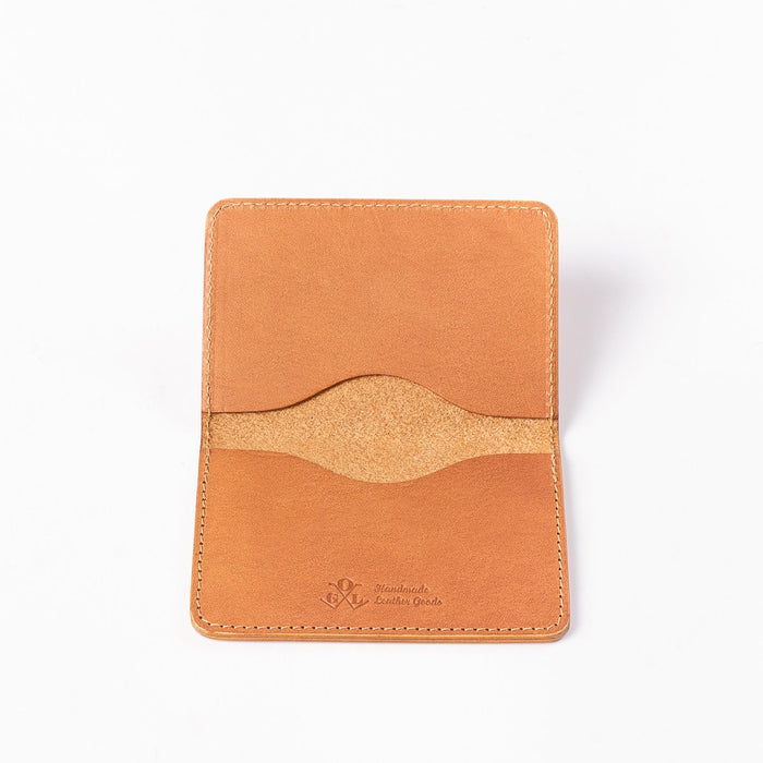 Obbi Good Label Kingsman Metro Flap Style Cardholder - Tan - A tan leather cardholder, displayed fully open, showcasing two internal card slots and embossed logo against a white background
