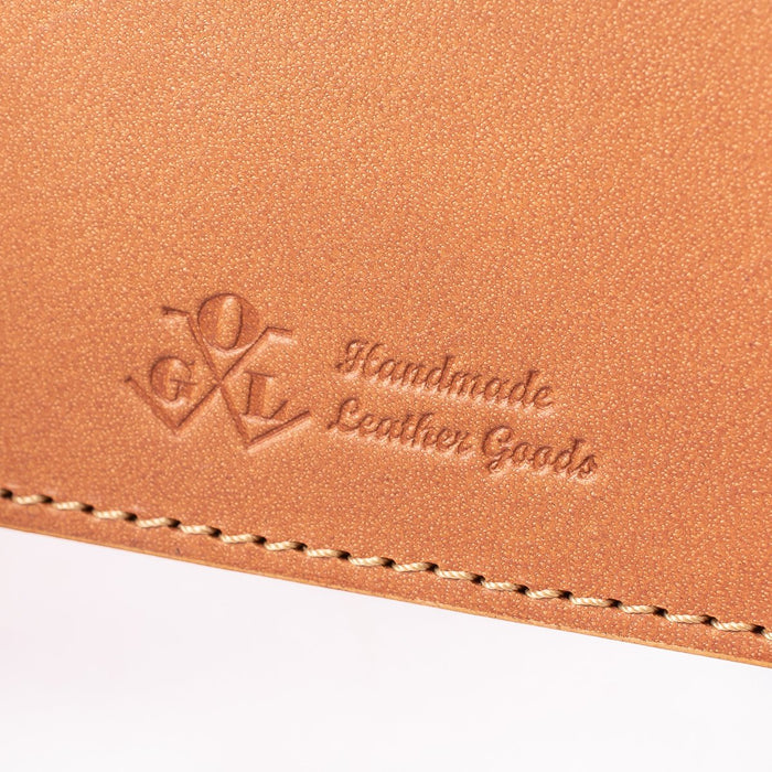 Obbi Good Label Kingsman Metro Flap Style Cardholder - Tan - Close up of logo inside of wallet against a white background