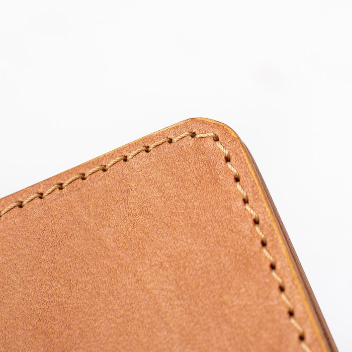 Obbi Good Label Kingsman Metro Flap Style Cardholder - Tan - Close up of tan stitching of wallet against a white background
