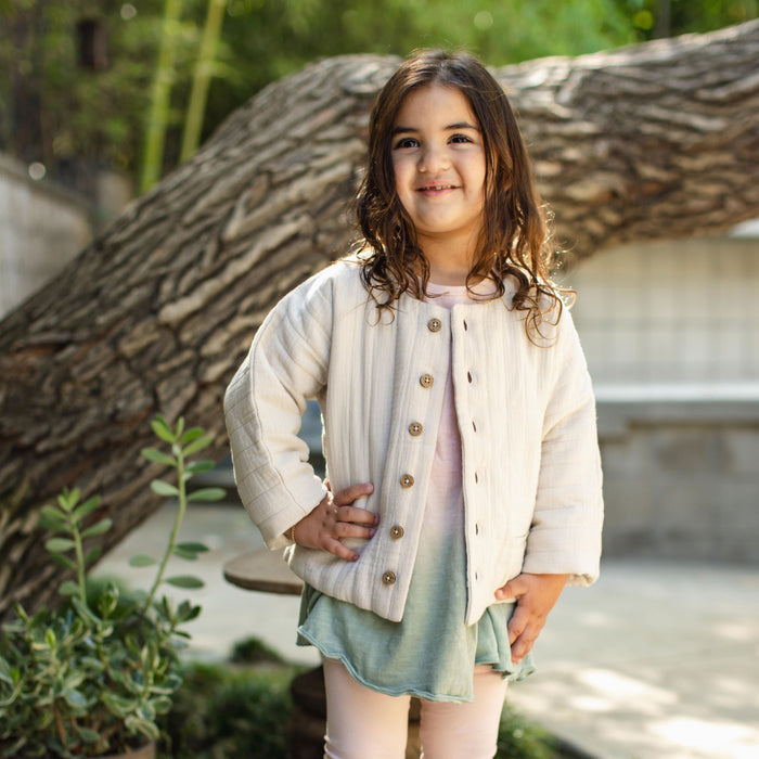 Off-white quilted organic cotton jacket with wood-look button placket and stand collar