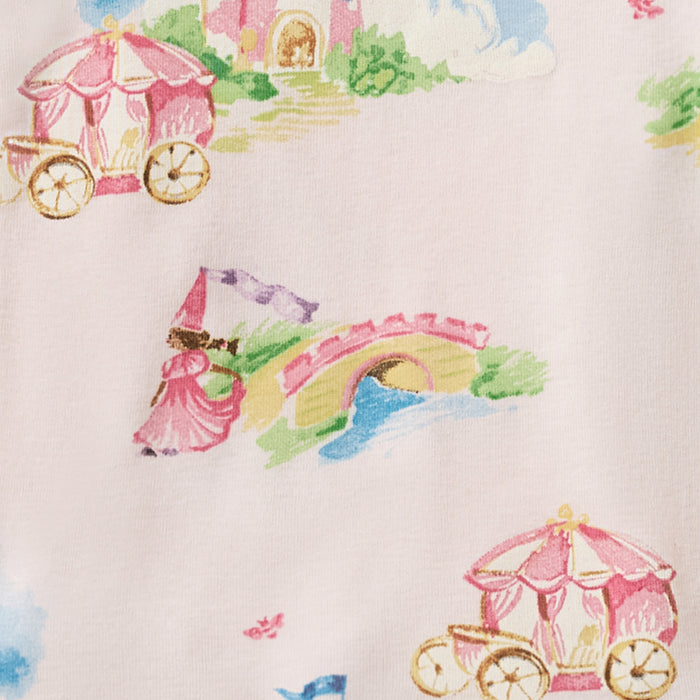 Organic cotton pajama fabric close-up, white with colorful carousel and castle illustrations
