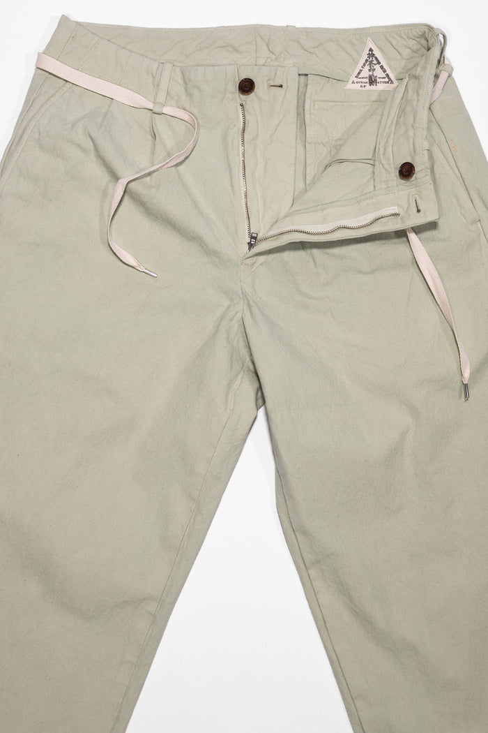 Seuvas Canvas Tapered 2-Tuck Pants (Regular) - Matcha. laid on back with zipper fly open