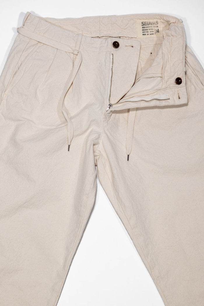 Seuvas Canvas Tapered 2-Tuck Pants (Regular) - Natural. laid on back with zipper fly open
