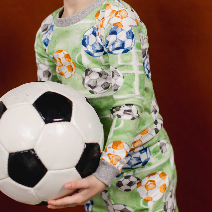 Green soccer-print two-piece organic cotton pajama set with long sleeves and pants