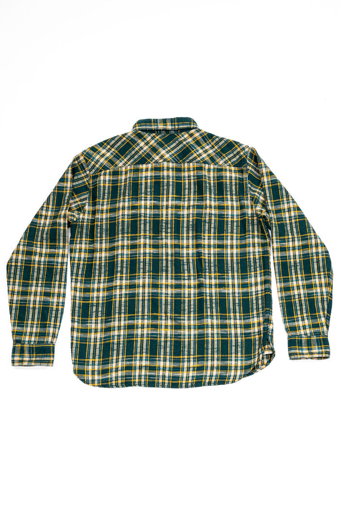 A long-sleeve plaid button-up shirt shown from the back, featuring a green, yellow, and white checkered pattern on a plain white background. 
UES 502655 Slubby Flannel Shirt - Green