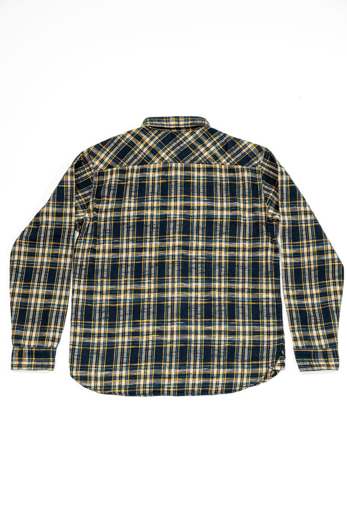 UES 502655 Slubby Flannel Shirt - Navy - A long-sleeve plaid button-up shirt shown from the back, featuring a navy blue, yellow, and white checkered pattern on a white background.