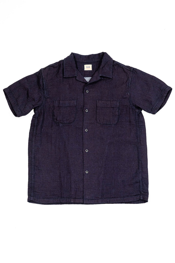 UES Herringbone Double Gauze Short Sleeve Shirt - Indigo - A short-sleeve button-up shirt in dark indigo denim, featuring two chest pockets and a relaxed fit, laid flat against a white background.